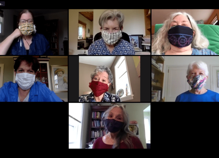 Seven older white women smiling under face masks in a Zoom collage.
