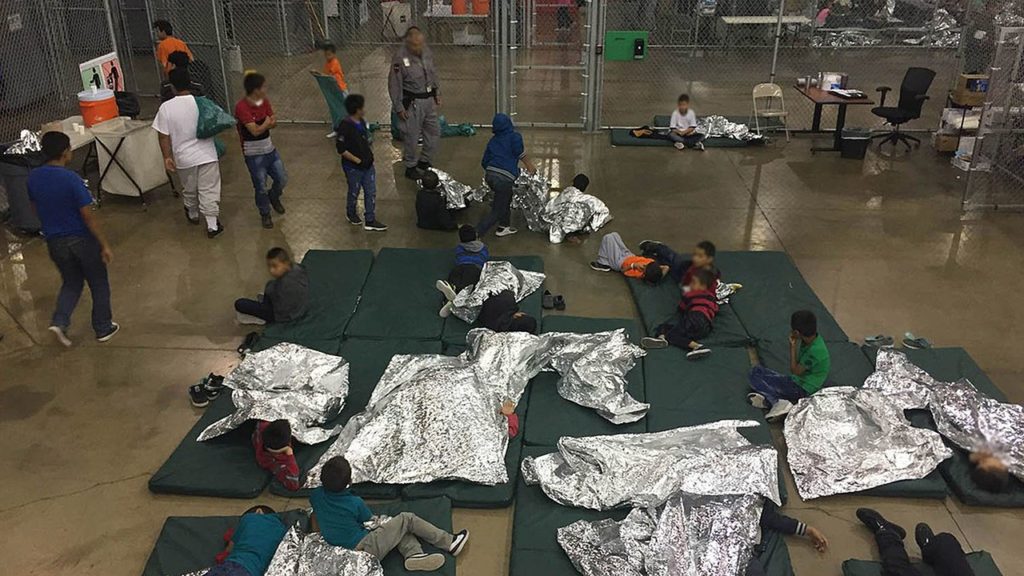 Children sleeping on floor mat under silver mylar blankets at the RS Custom and Border Protection Detention Facility ins McAllen Texas.
