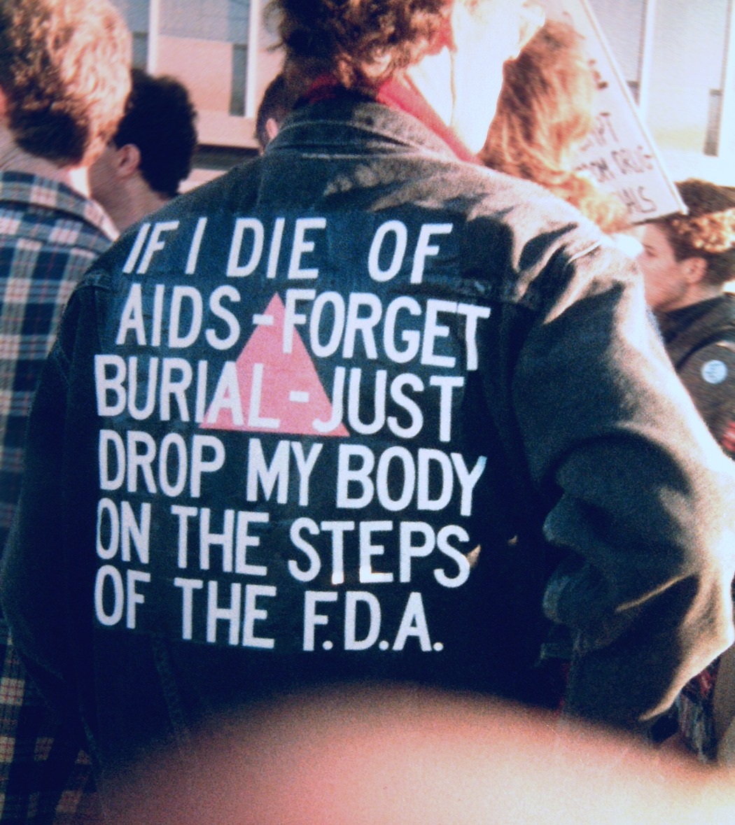 Man wearing jacket with AIDS advocacy message on the back.